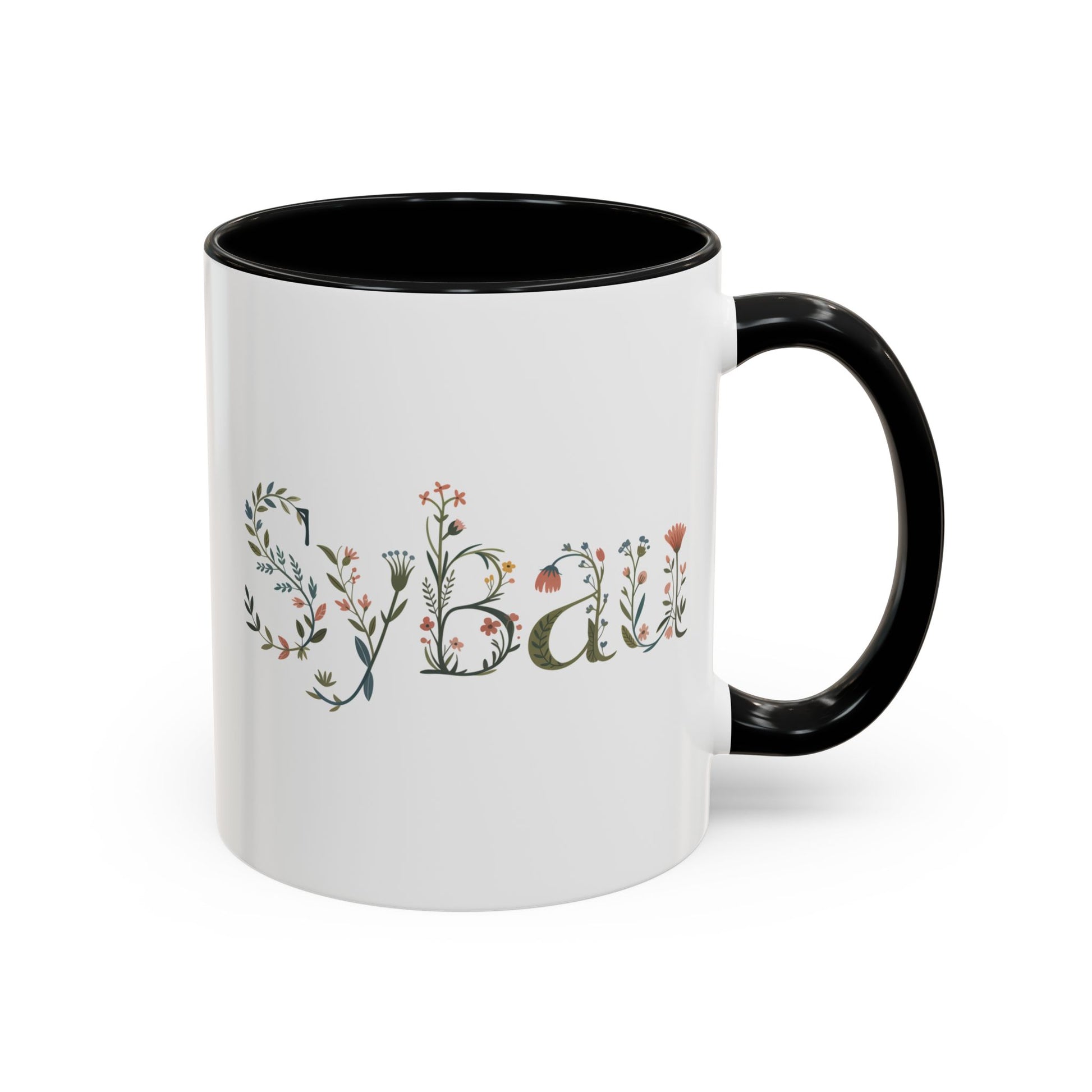 White mug with black handle featuring decorative text and floral elements on a white background