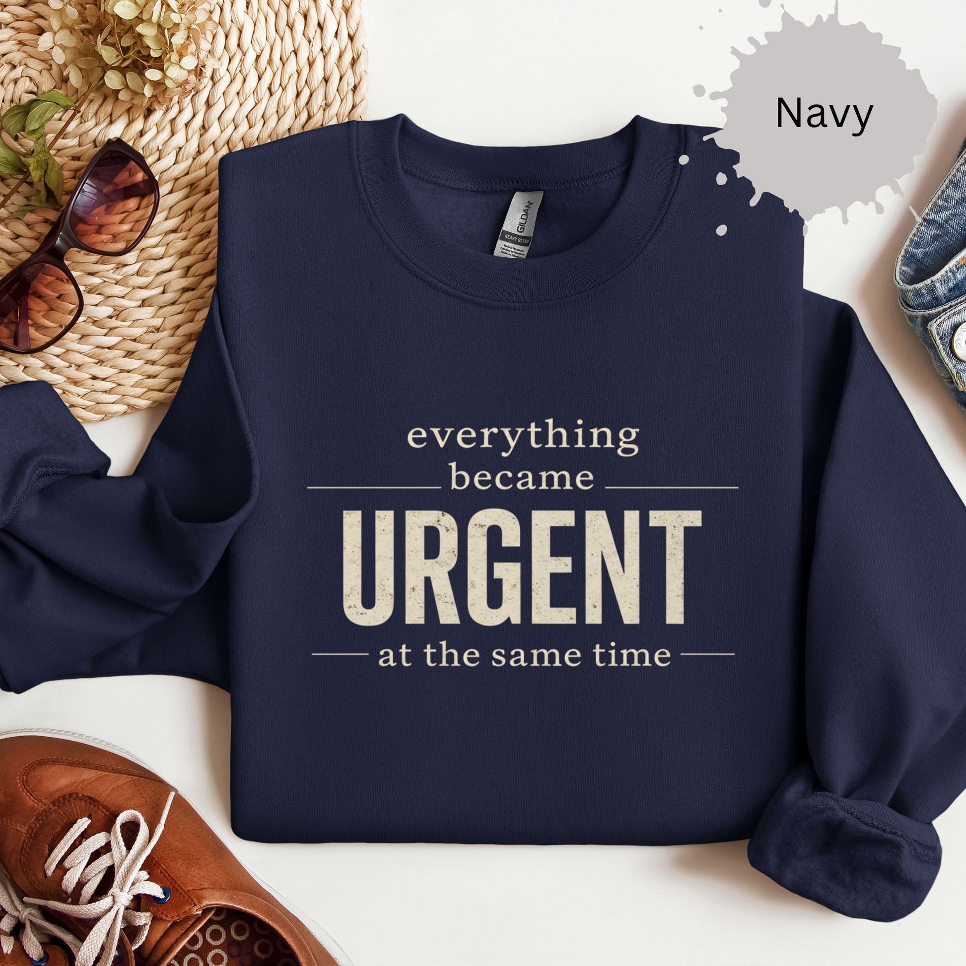 Crewneck sweatshirt with a bold text reading “Everything became urgent at the same time.”