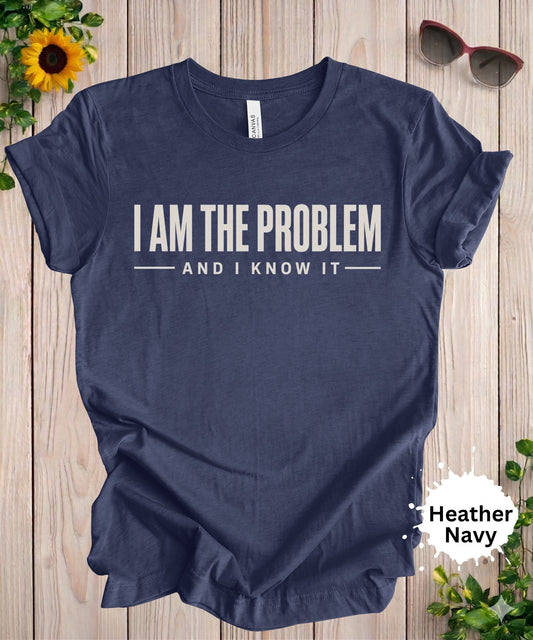 Women’s graphic T-shirt featuring the phrase “I am the problem and I know it” in a bold typography