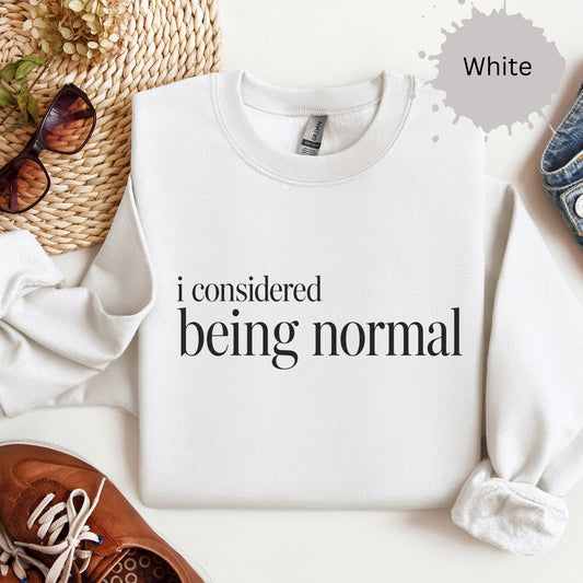 Womens sweatshirt with minimalist text reading “I considered being normal”