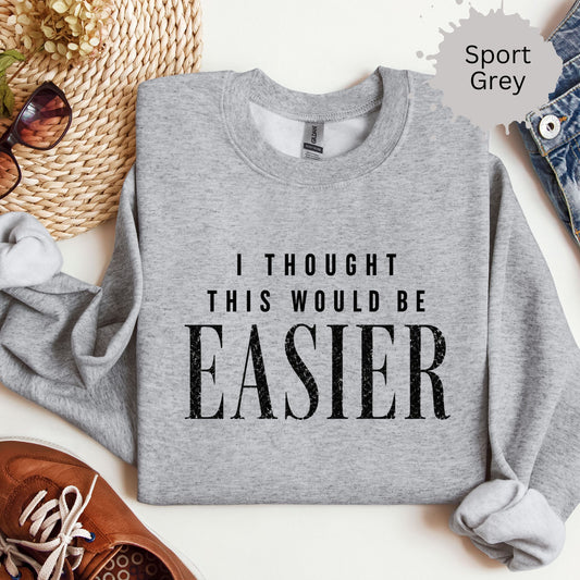 Crewneck sweatshirt with distressed a bold distressed text reading “I thought this would be easier.”