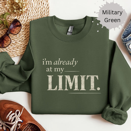 Sweatshirt with distressed typography reading “I’m already at my limit”
