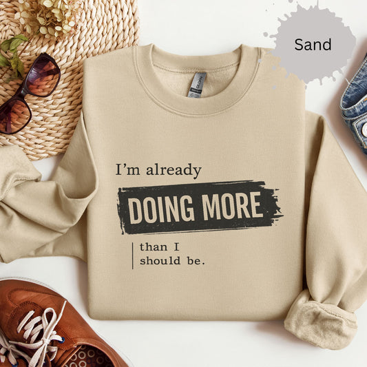 Sweatshirt with distressed typography reading “I’m already doing more than I should be”