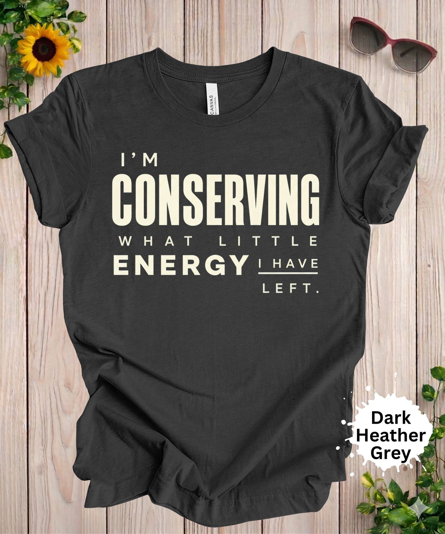 Women’s graphic T-shirt with the phrase “I’m conserving what little energy I have left” in bold typography