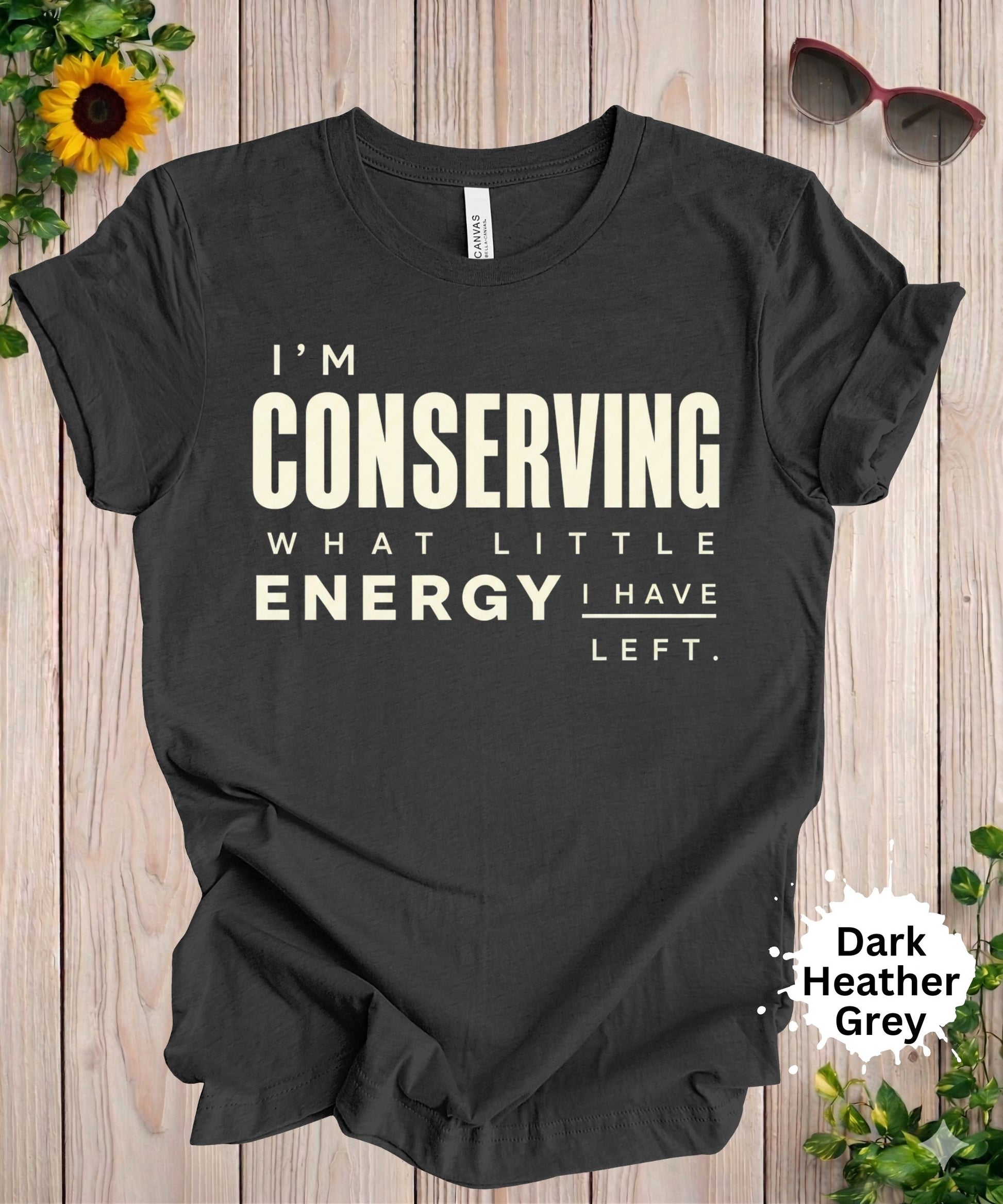 Women’s graphic T-shirt with the phrase “I’m conserving what little energy I have left” in bold typography