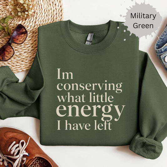 Sweatshirt with minimalist typography reading “I’m conserving what little energy I have left”
