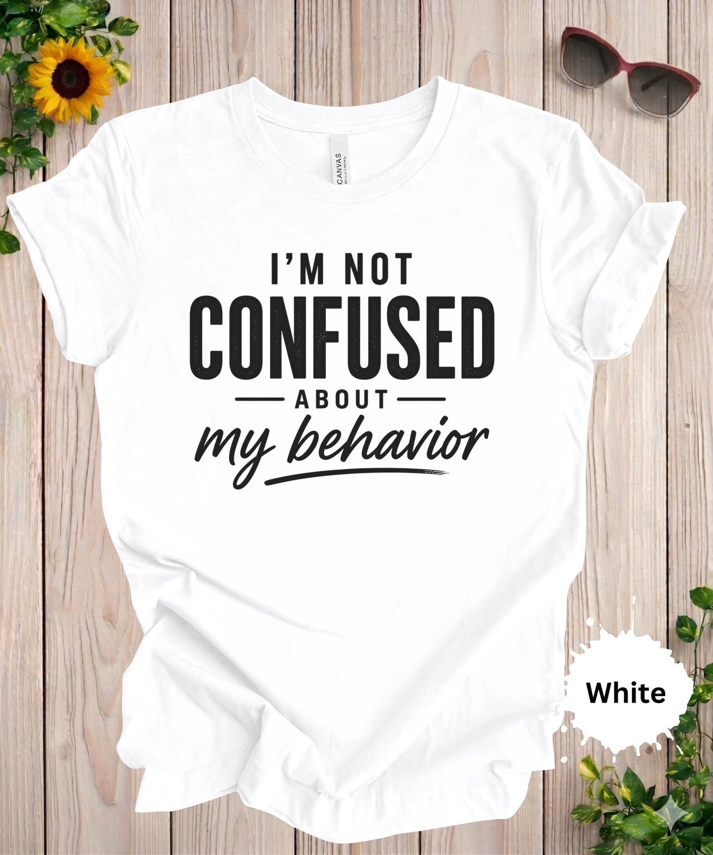 Women’s graphic T-shirt featuring the phrase “I’m not confused about my behavior” in bold and scrip typography