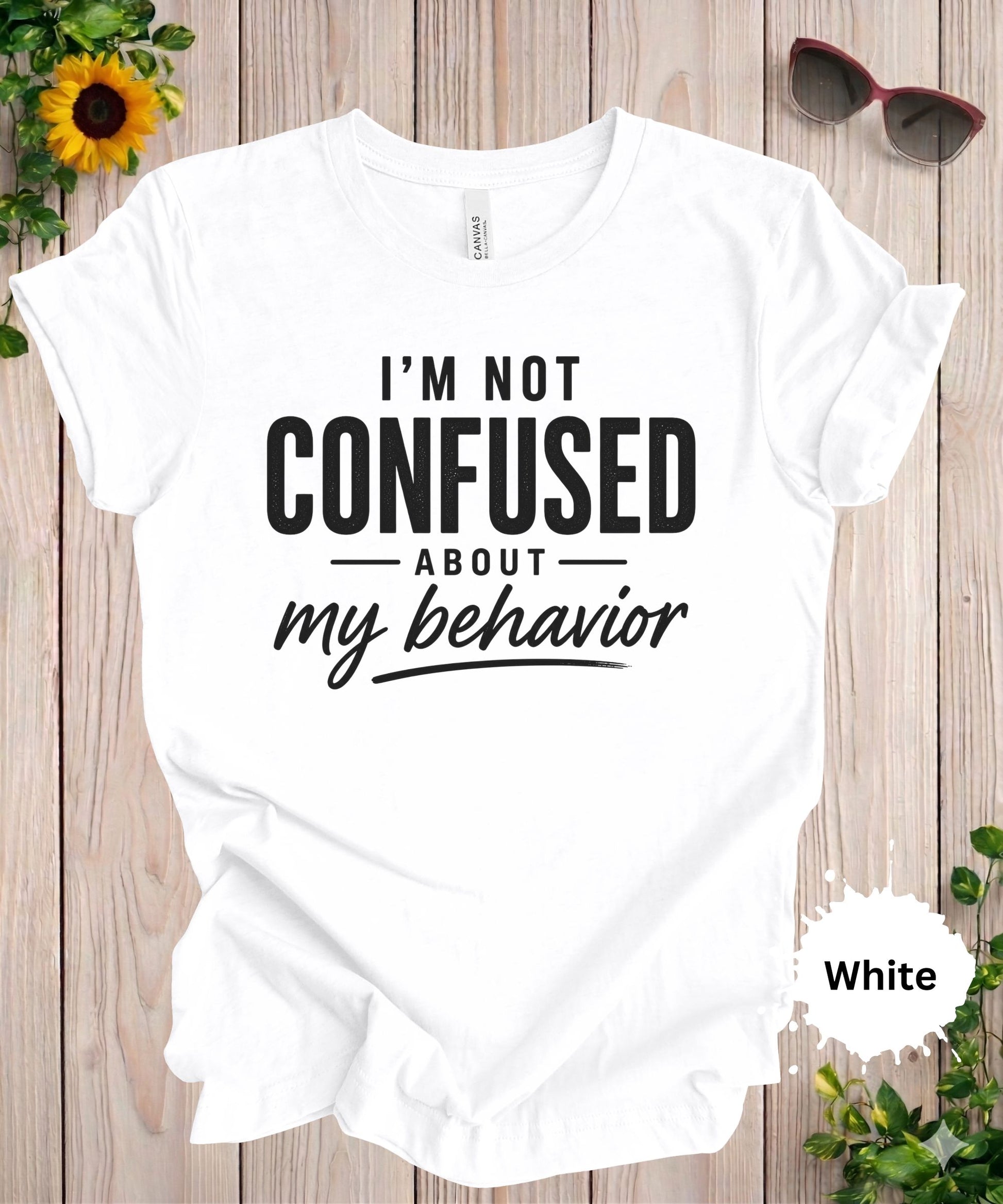 Women’s graphic T-shirt featuring the phrase “I’m not confused about my behavior” in bold and scrip typography