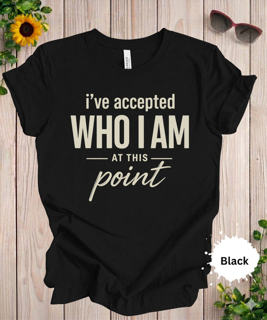 Women’s graphic T-shirt featuring the phrase “I’ve accepted who I am at this point” in bold typography