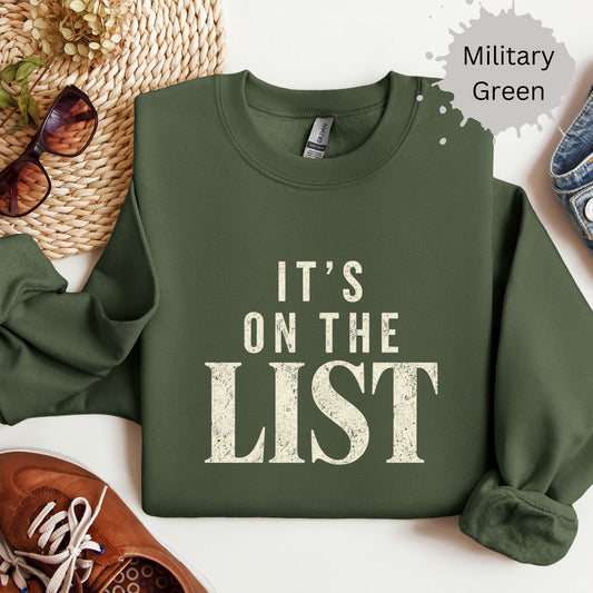Crewneck sweatshirt with distressed bold text reading “It’s on the list.”