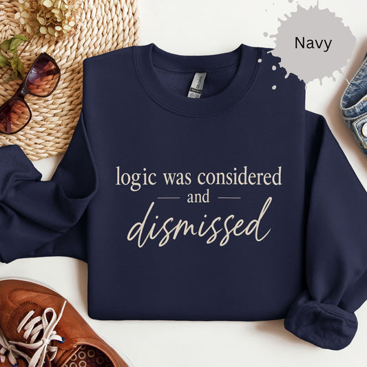 Sweatshirt with typography reading “logic was considered and dismissed”