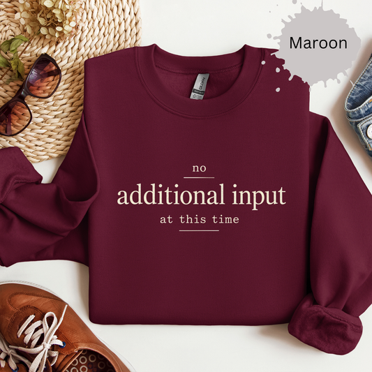Crewneck sweatshirt with minimalist text reading “No additional input at this time.”