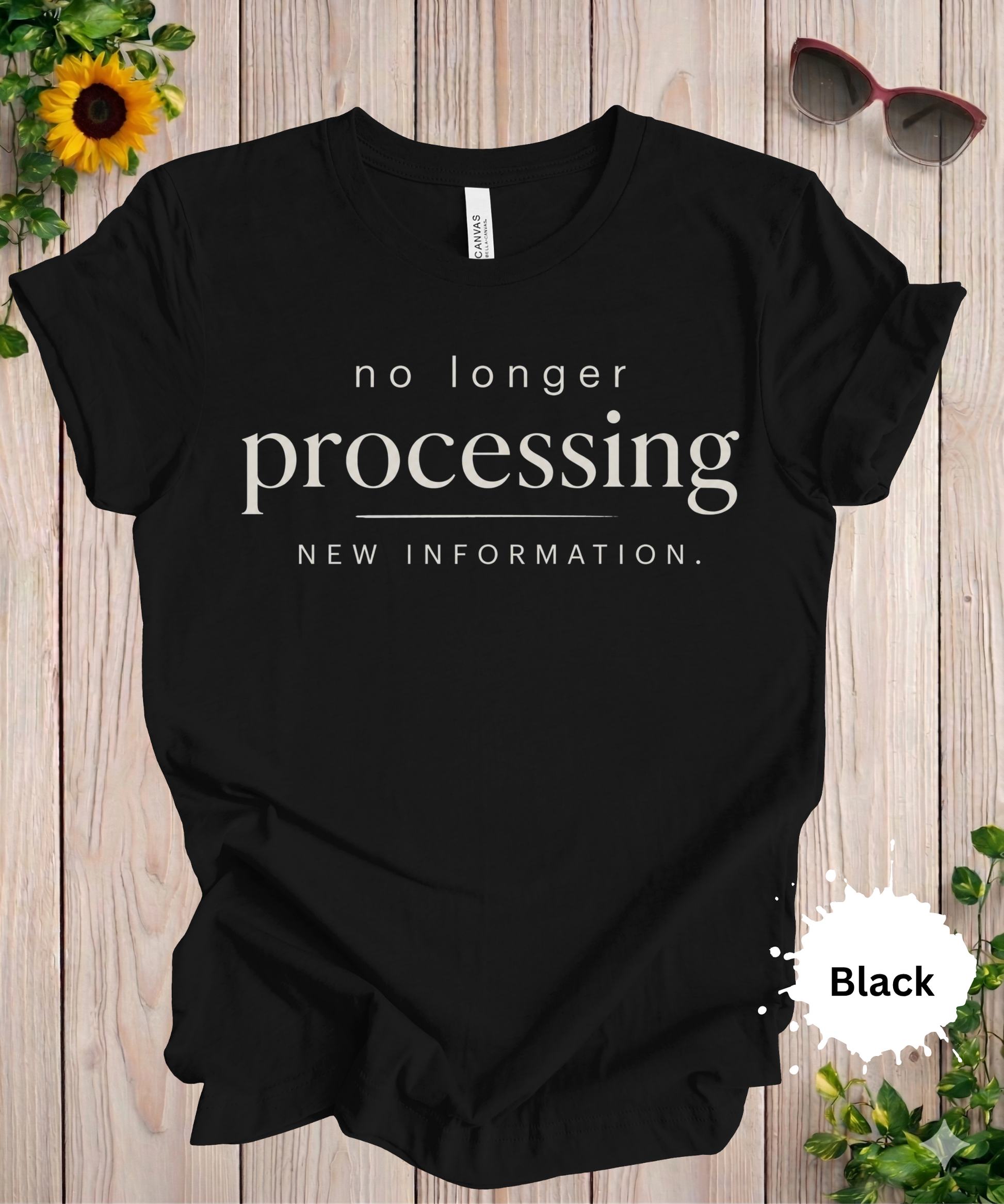 women’s graphic T-shirt with the phrase “no longer processing new information” in minimalist typography