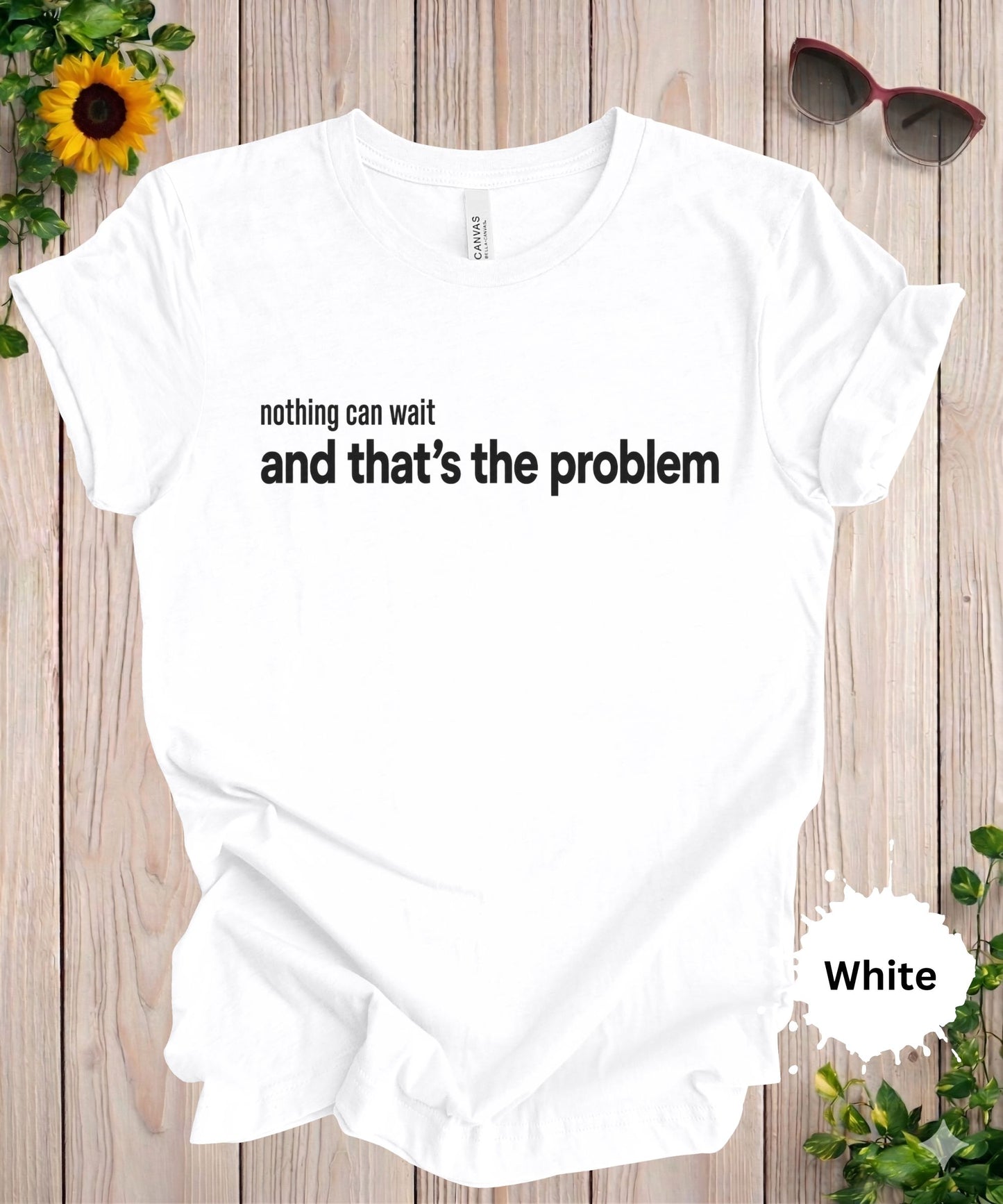 Women’s graphic T-shirt featuring the phrase “nothing can wait and that’s the problem” in minimalist typography