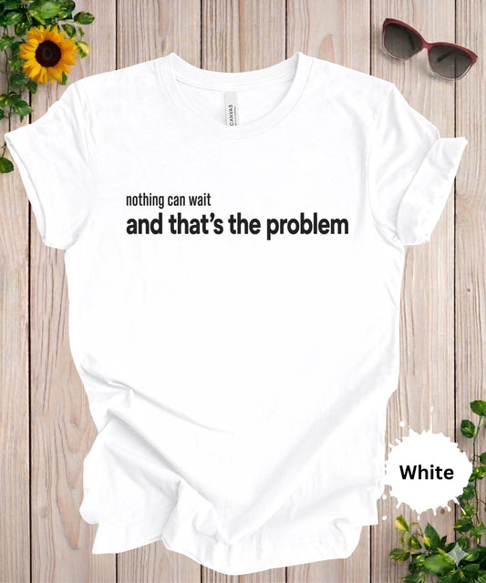 Women’s graphic T-shirt featuring the phrase “nothing can wait and that’s the problem” in minimalist typography