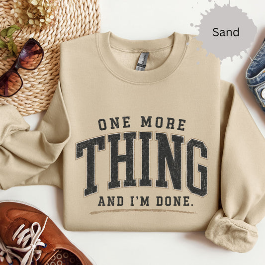 Crewneck sweatshirt with distressed varsity text reading “One more thing and I’m done.”