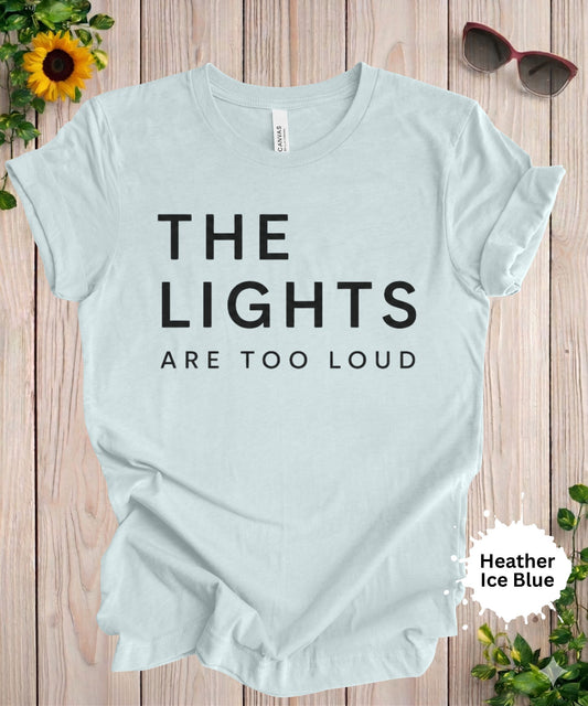 Women’s graphic T-shirt with the phrase “the lights are too loud” in bold minimalist typography