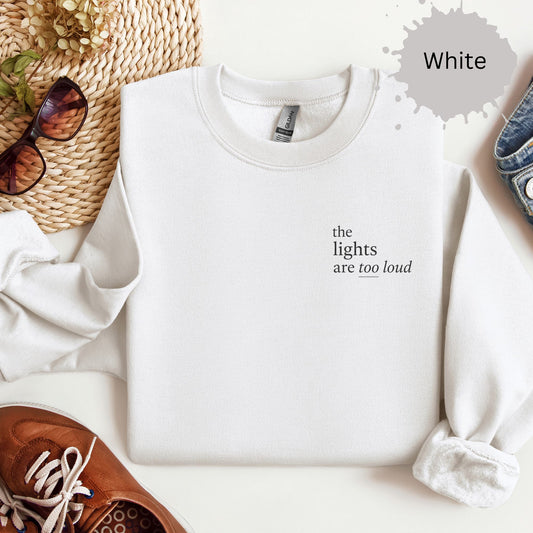 Crewneck sweatshirt with small text reading “The lights are too loud.”