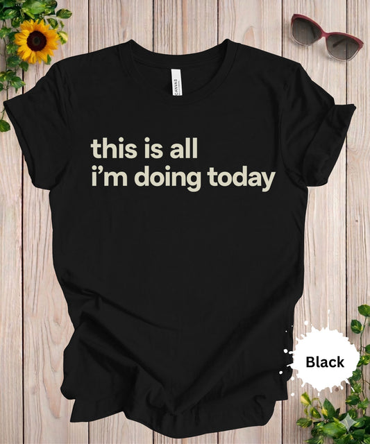 Women’s graphic T-shirt with the phrase “this is all i’m doing today” in bold black typography