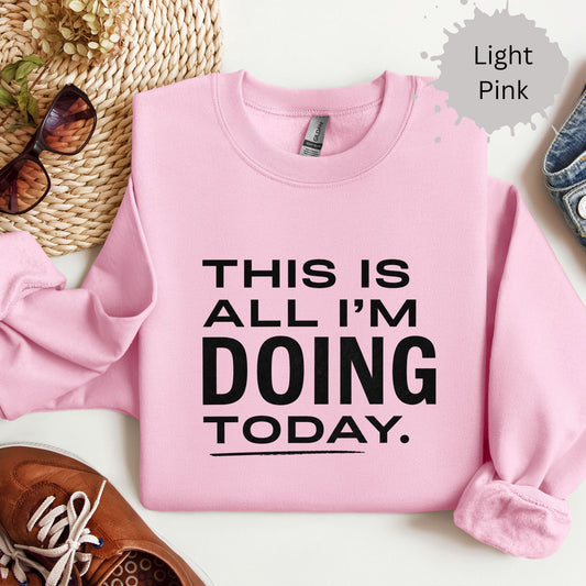 Sweatshirt with bold typography reading “This is all I’m doing today”