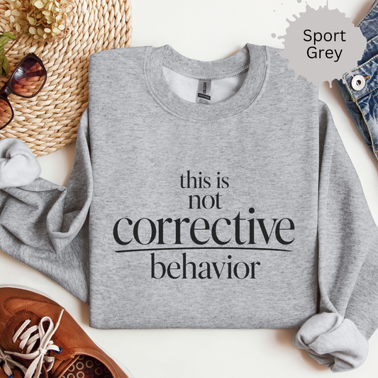 Womens sweatshirt with minimalist text reading “this is not corrective behavior”