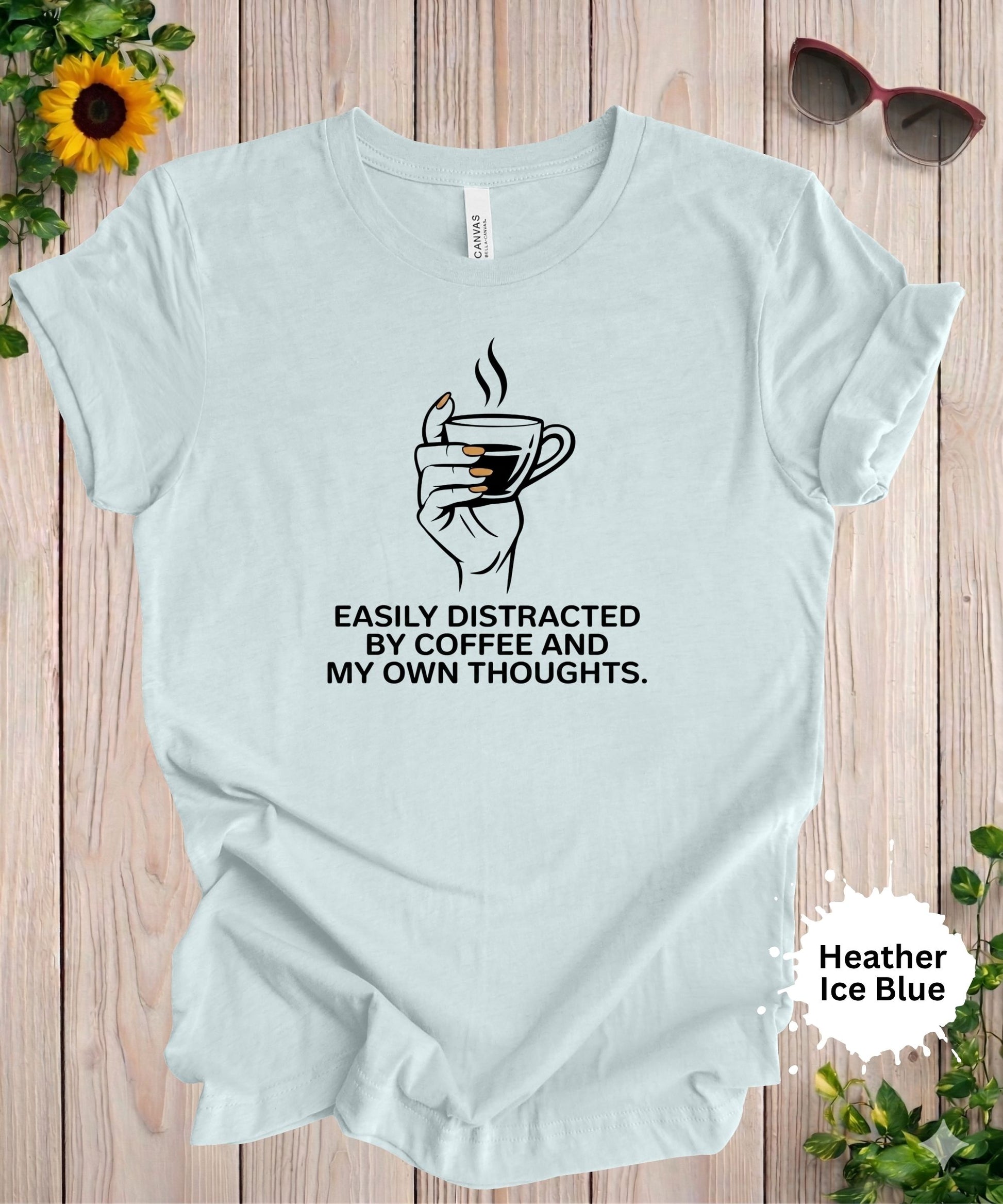 Woman wearing easily distracted by coffee and my own thoughts graphic t-shirt with minimalist coffee cup design