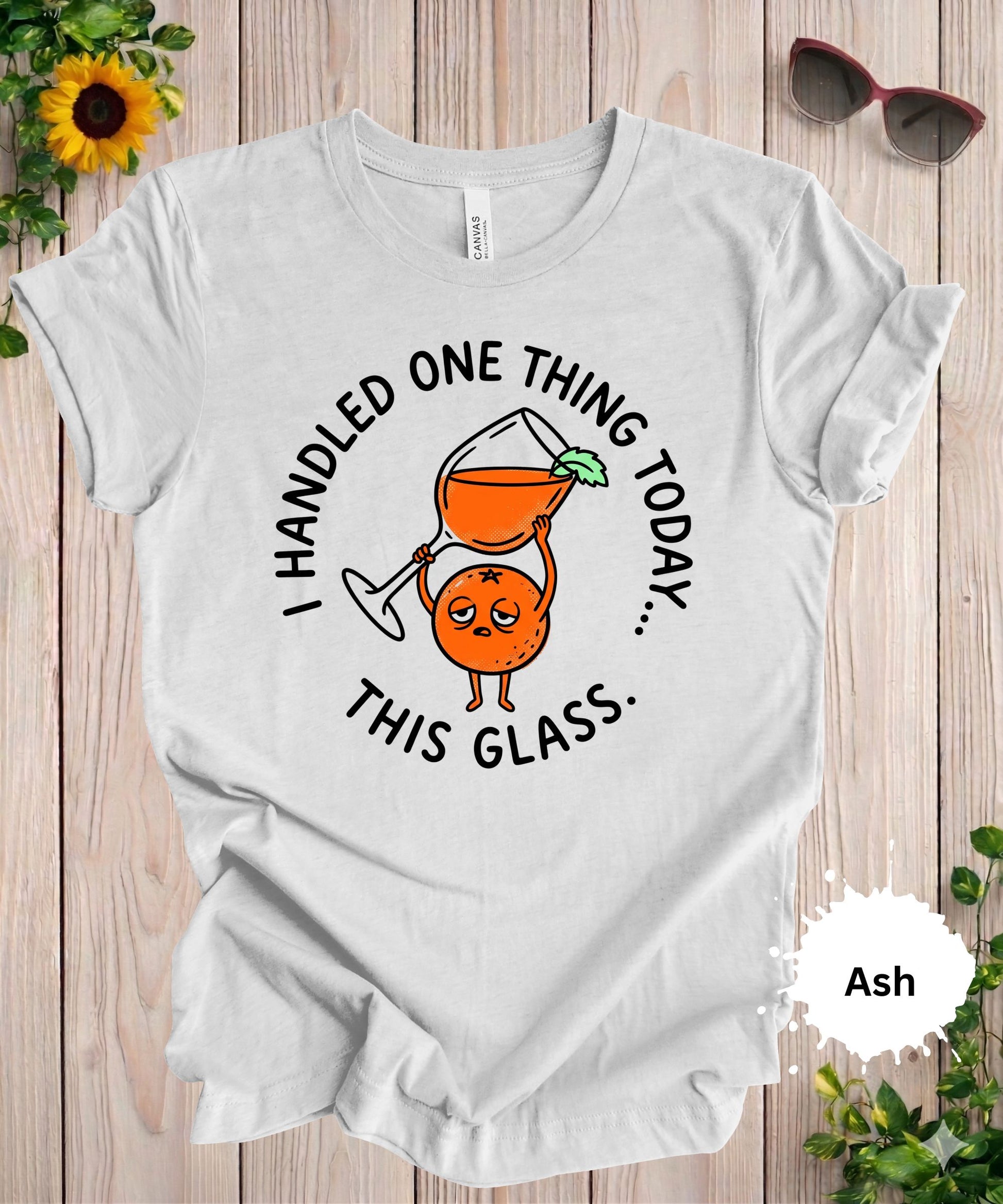 Woman wearing I handled one thing today this glass funny graphic t-shirt with cocktail illustration
