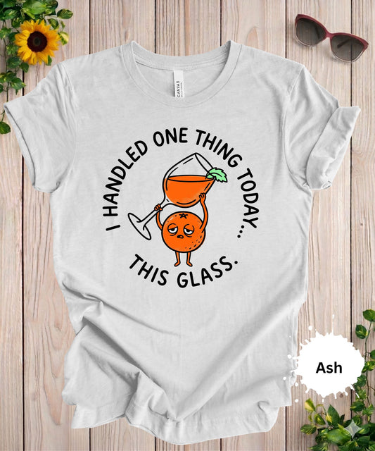 Woman wearing I handled one thing today this glass funny graphic t-shirt with cocktail illustration