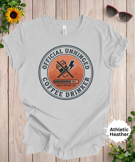 Woman wearing officially unhinged coffee drinker graphic t-shirt with badge style caffeine design