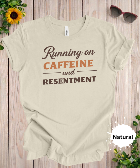 Funny coffee t-shirt with the phrase running on caffeine and resentment in a clean typography design