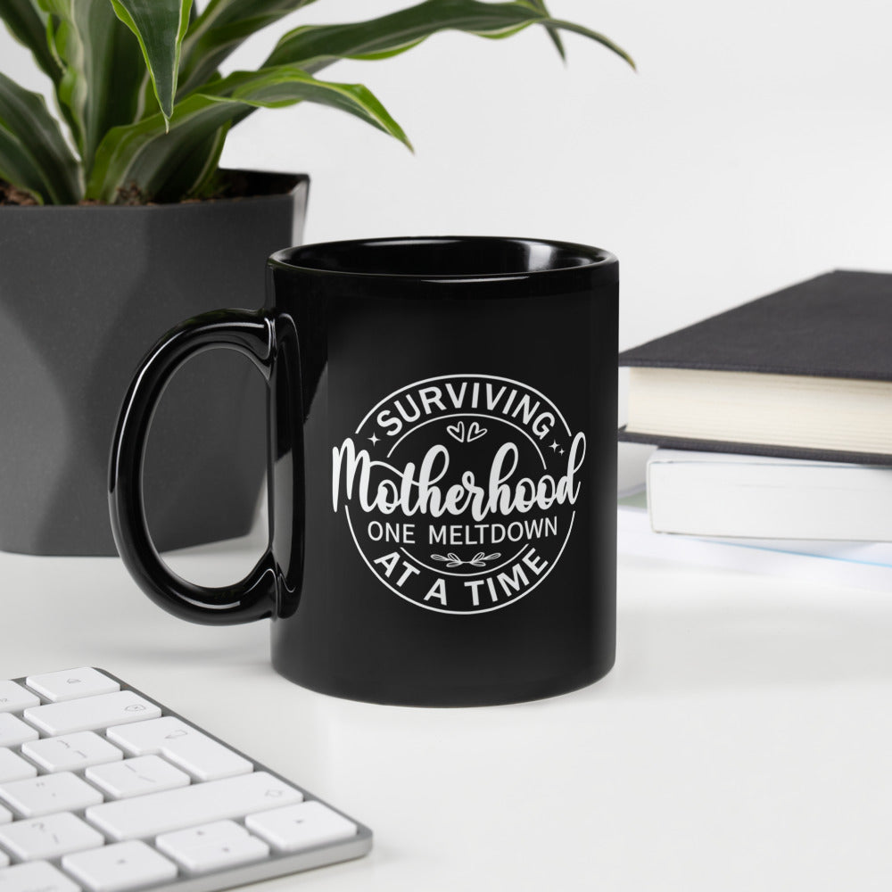 Surviving Motherhood One Meltdown at a Time Black Ceramic Coffee Mug